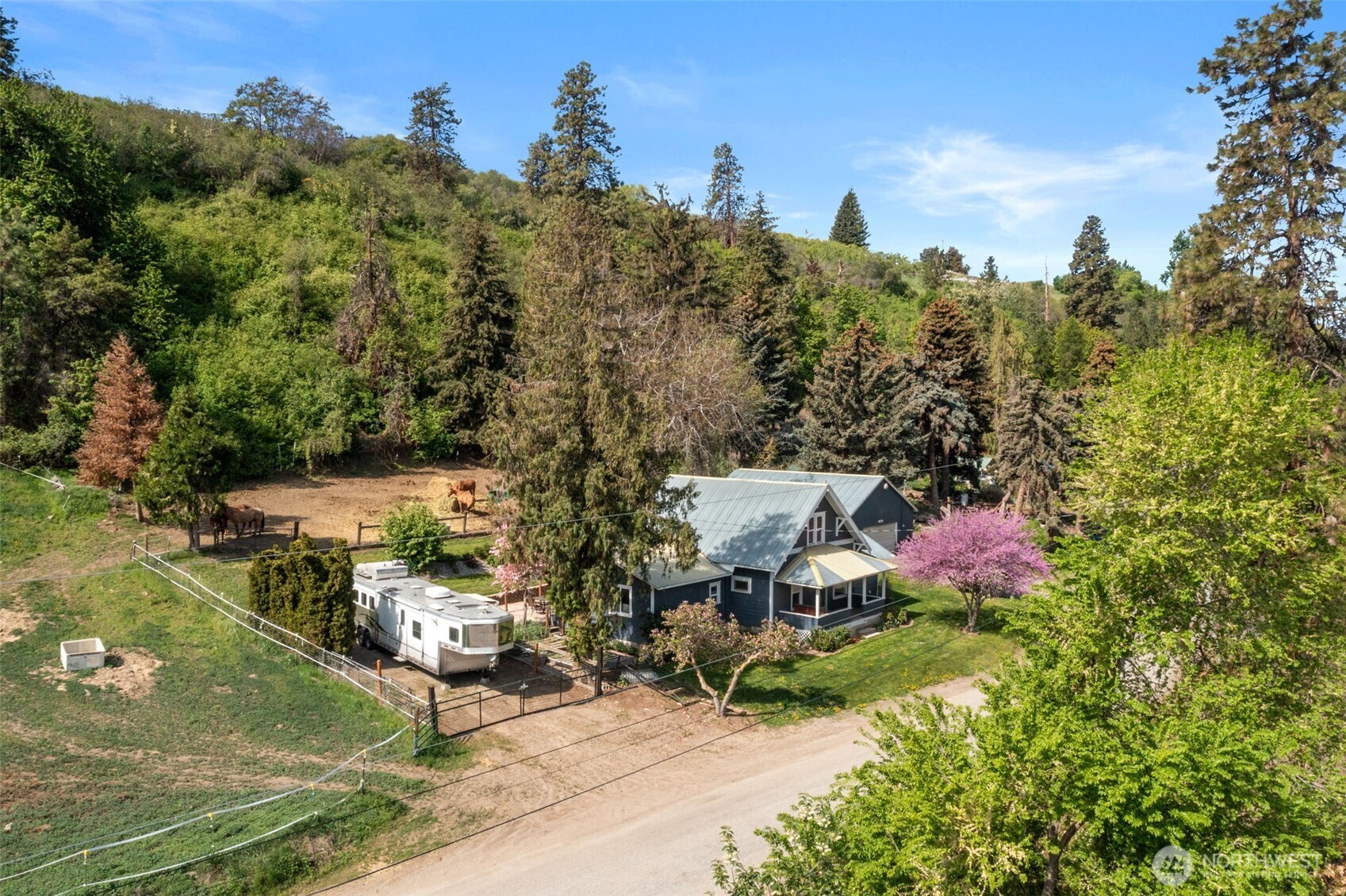 a aerial view of a house with a yard basket ball court and outdoor seating
