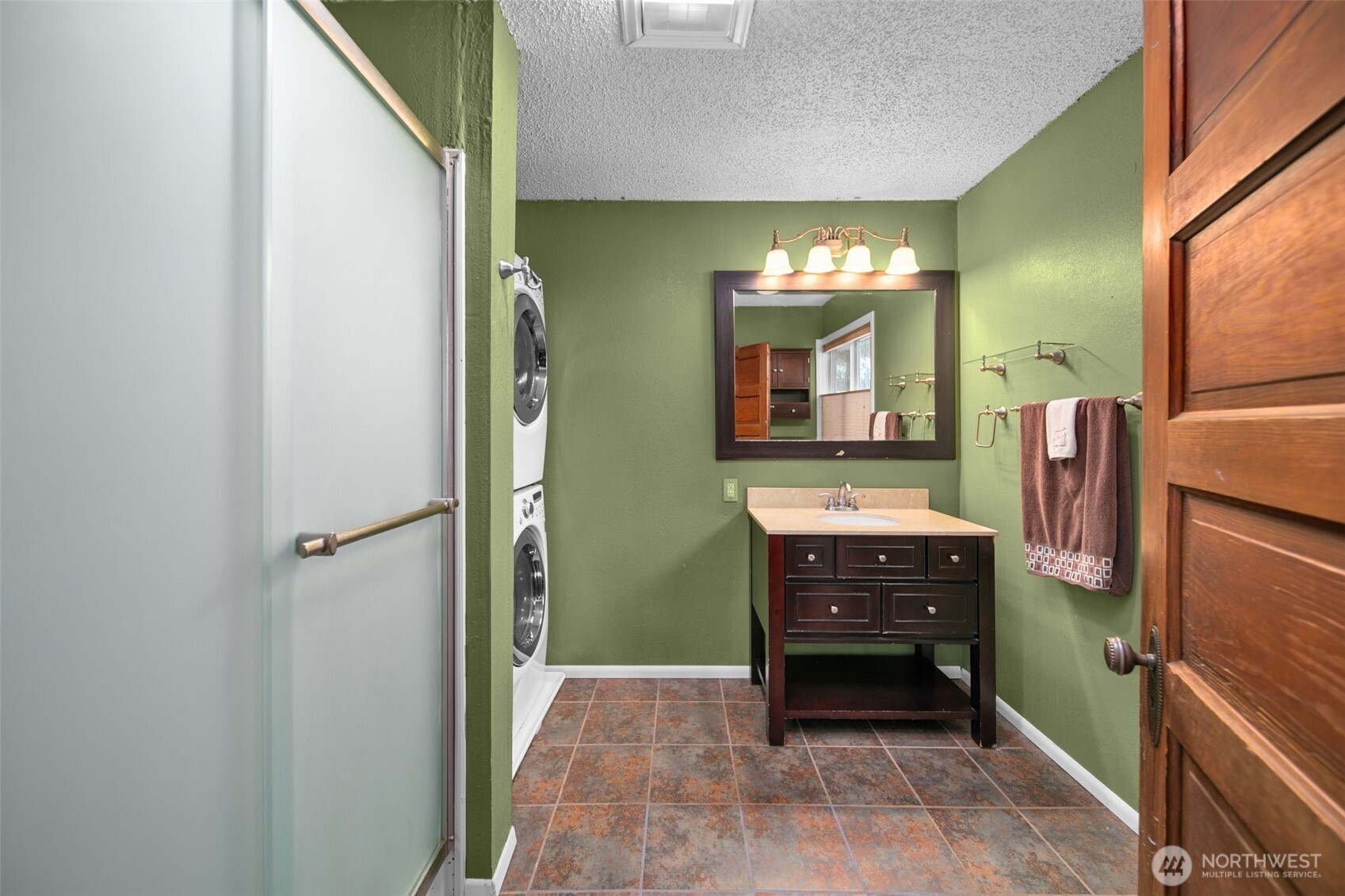 4693 Valley Street Monitor, WA 98836 - Photo 16 of 40 a bathroom with a sink a mirror and a bathtub