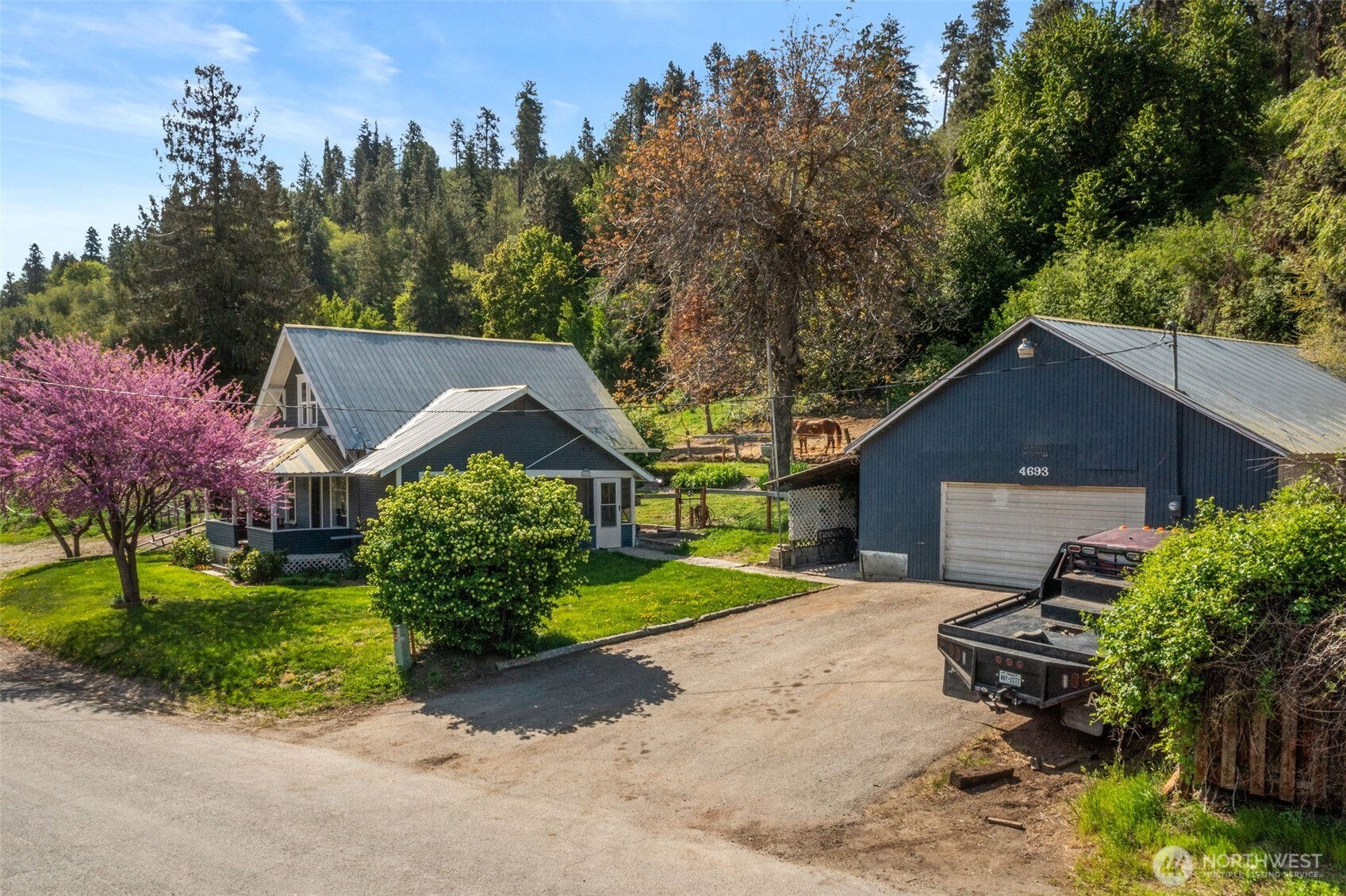 4693 Valley Street Monitor, WA 98836 - Photo 25 of 40 a front view of a house with a yard and garage