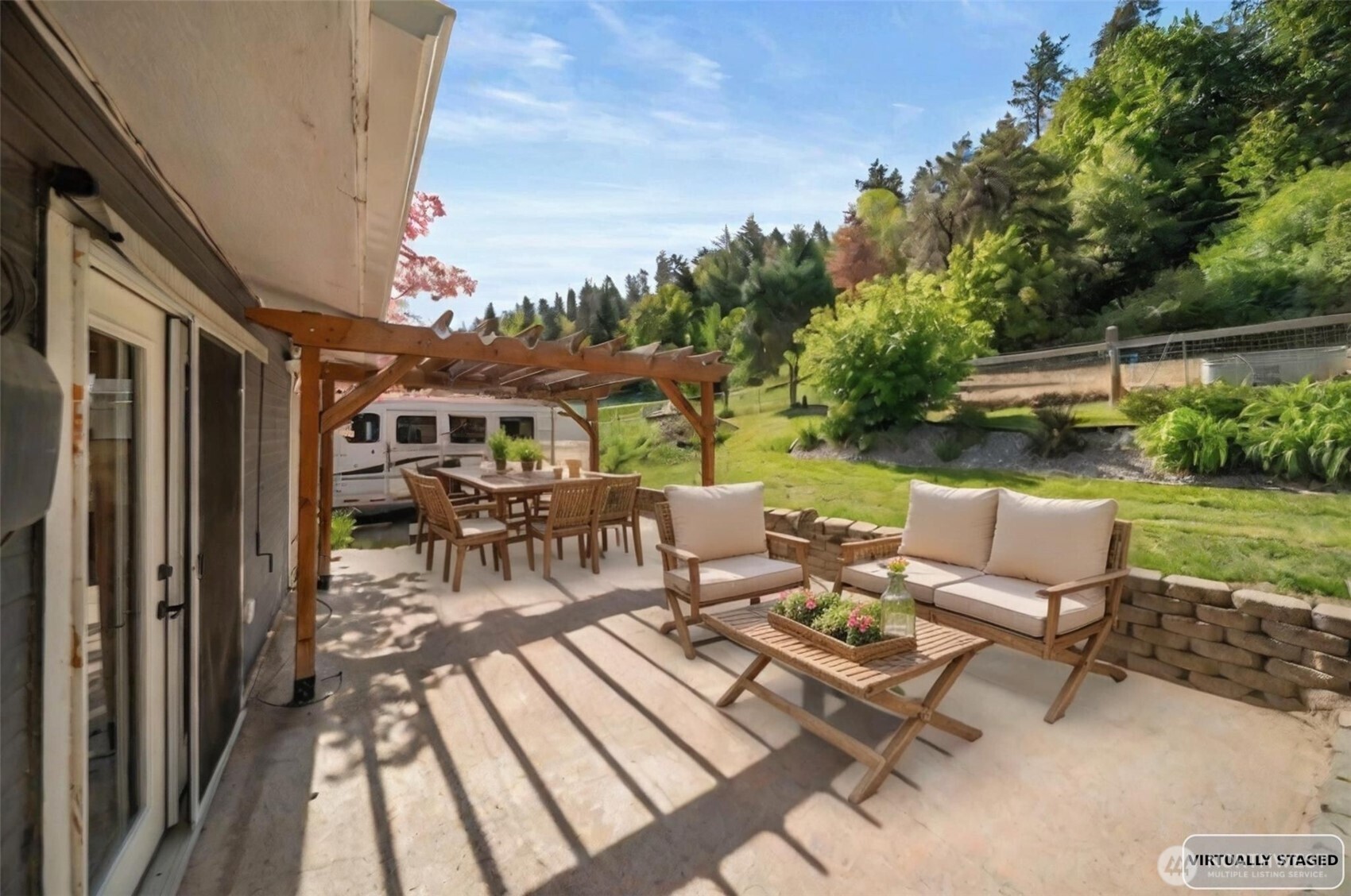 4693 Valley Street Monitor, WA 98836 - Photo 30 of 40 a view of a patio with table and chairs potted plants with wooden floor and fence