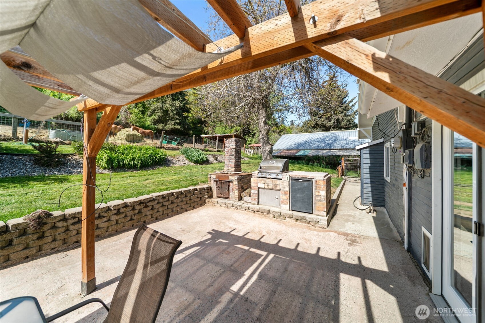 4693 Valley Street Monitor, WA 98836 - Photo 31 of 40 a view of a patio with a table chairs and a yard