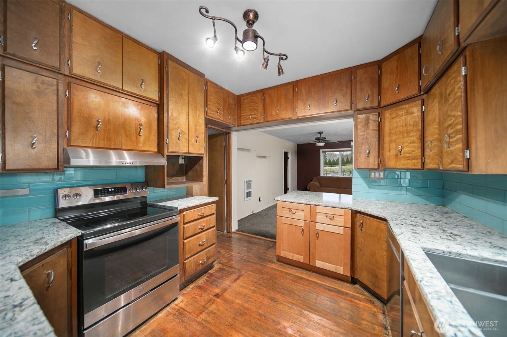 4693 Valley Street Monitor, WA 98836 - Photo 8 of 40 a kitchen with stainless steel appliances granite countertop a stove a sink and a microwave