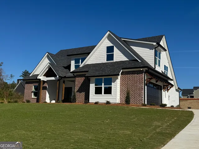 a front view of a house with a garden