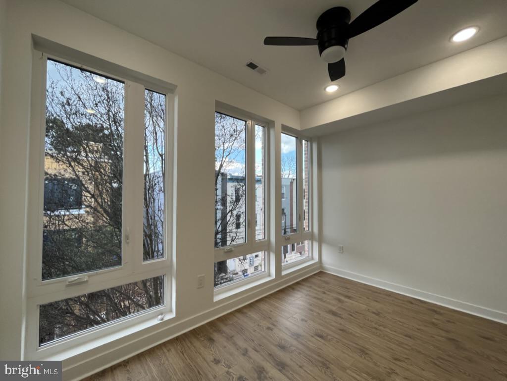 2117 North 8th Street Philadelphia, PA 19122 - Photo 5 of 17 an empty room with wooden floor and windows