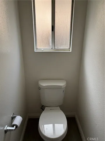 a view of a room with wooden floor and white walls