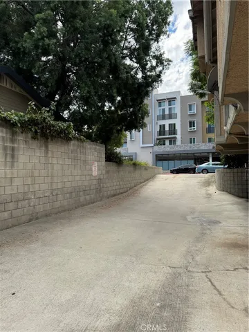 a view of balcony with wooden floor and floor to ceiling window