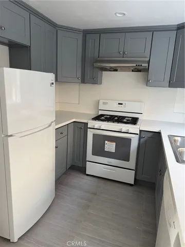 a white kitchen with a stove top oven