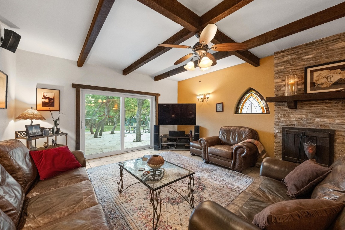 5200 Bell Springs Road Dripping Springs, TX 78620 - Photo 23 of 36 a living room with furniture a fireplace and a large window