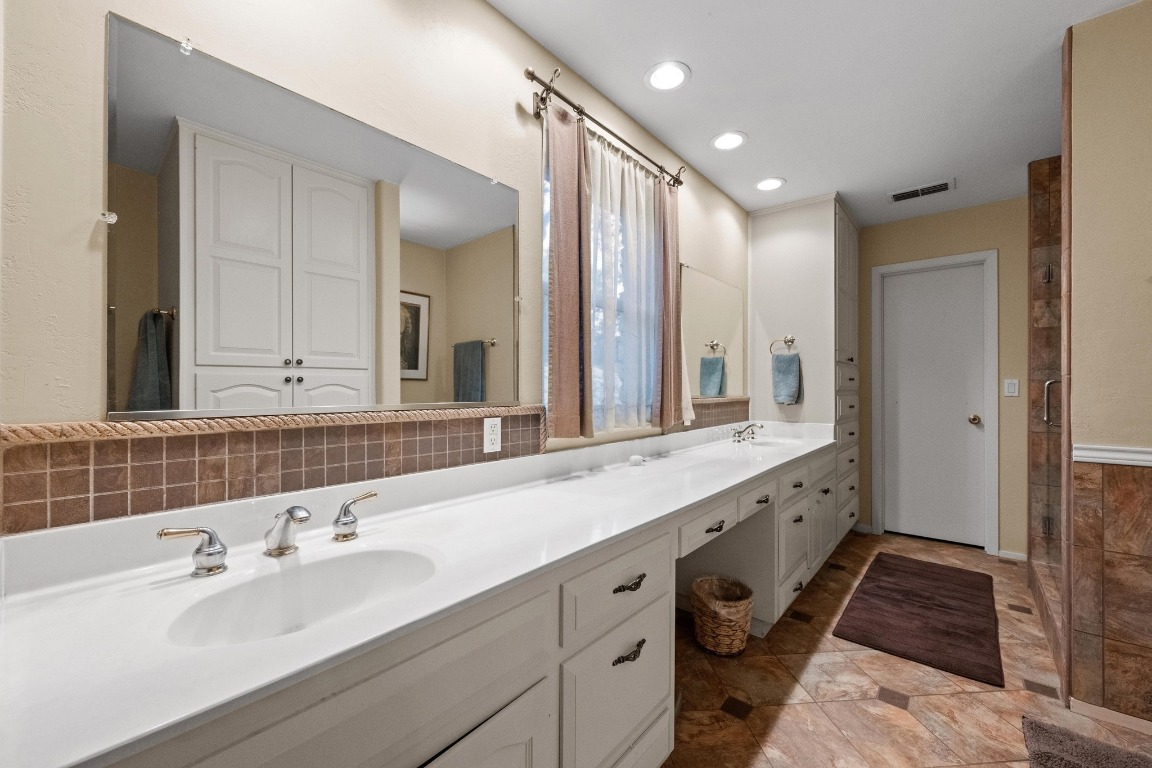 5200 Bell Springs Road Dripping Springs, TX 78620 - Photo 28 of 36 a bathroom with double vanity sinks and a large mirror