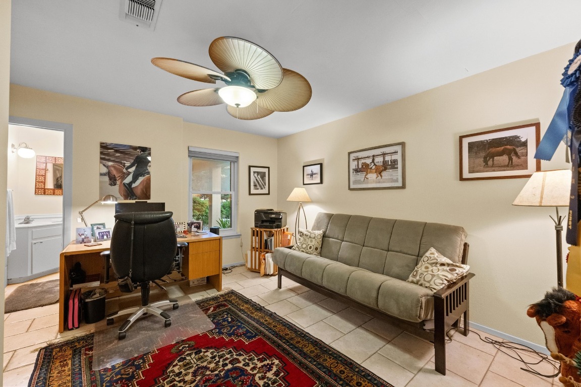 5200 Bell Springs Road Dripping Springs, TX 78620 - Photo 29 of 36 a living room with furniture ceiling fan and a rug