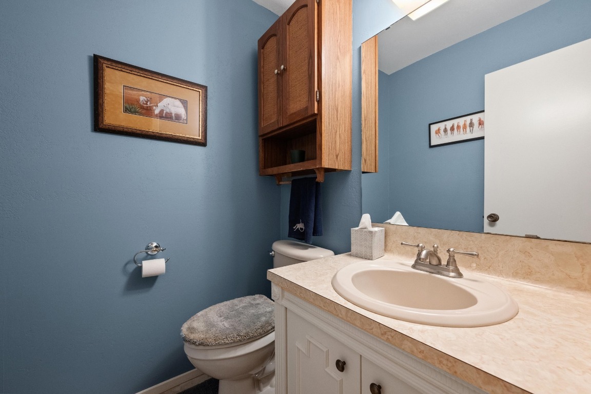 5200 Bell Springs Road Dripping Springs, TX 78620 - Photo 33 of 36 a bathroom with a toilet sink and mirror