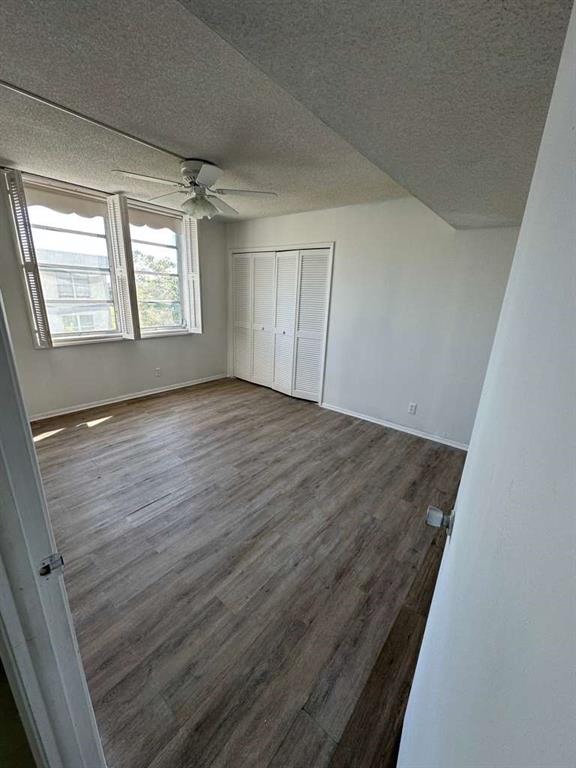 2681 South Course Drive, Unit 612 Pompano Beach, FL 33069 - Photo 11 of 27 an empty room with wooden floor and windows