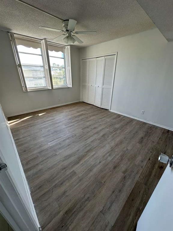 2681 South Course Drive, Unit 612 Pompano Beach, FL 33069 - Photo 18 of 27 an empty room with wooden floor and windows