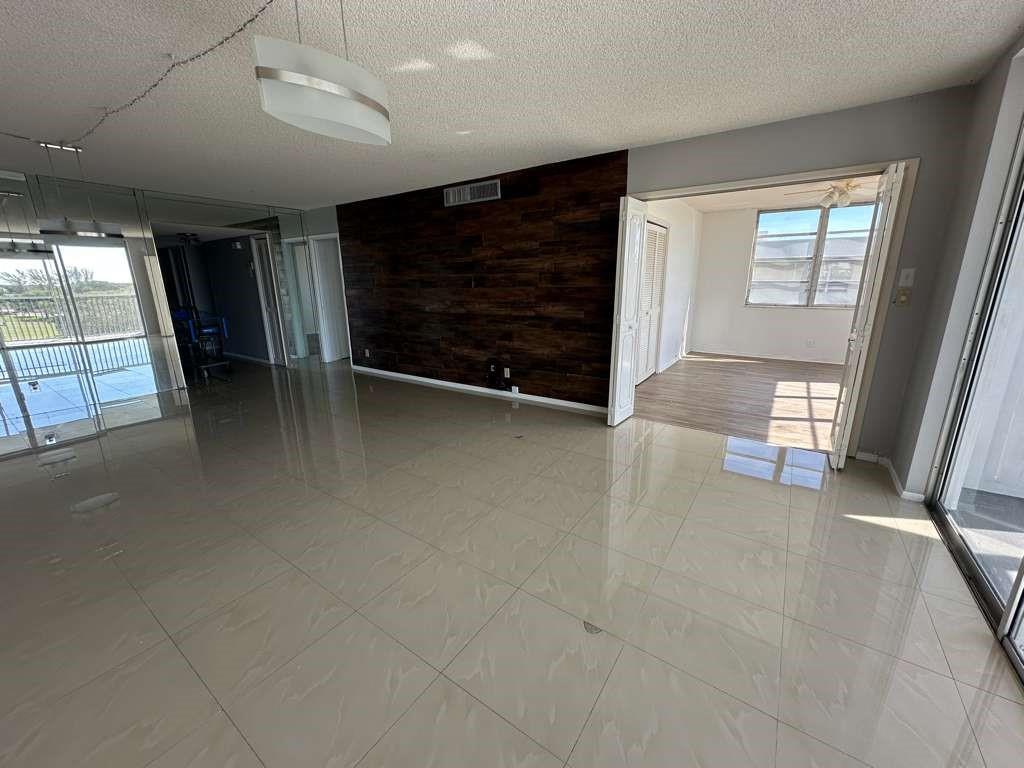 2681 South Course Drive, Unit 612 Pompano Beach, FL 33069 - Photo 19 of 27 a view of an empty room with a fireplace and a window