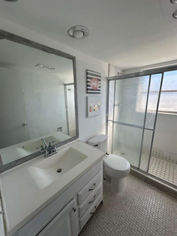 2681 South Course Drive, Unit 612 Pompano Beach, FL 33069 - Photo 20 of 27 a bathroom with a sink a toilet a mirror and shower