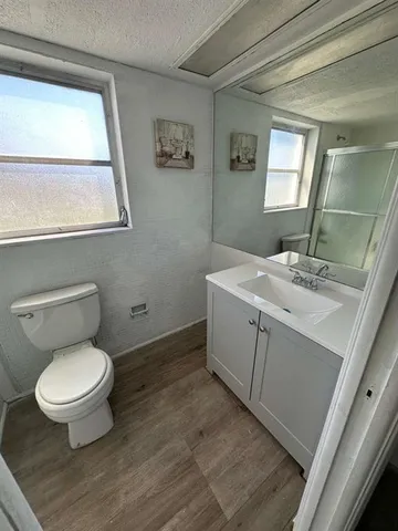 a bathroom with a toilet sink and window