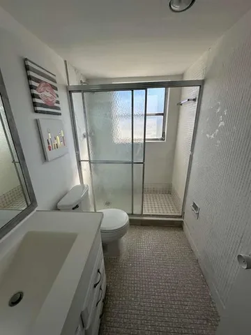 a bathroom with a sink a toilet and a shower