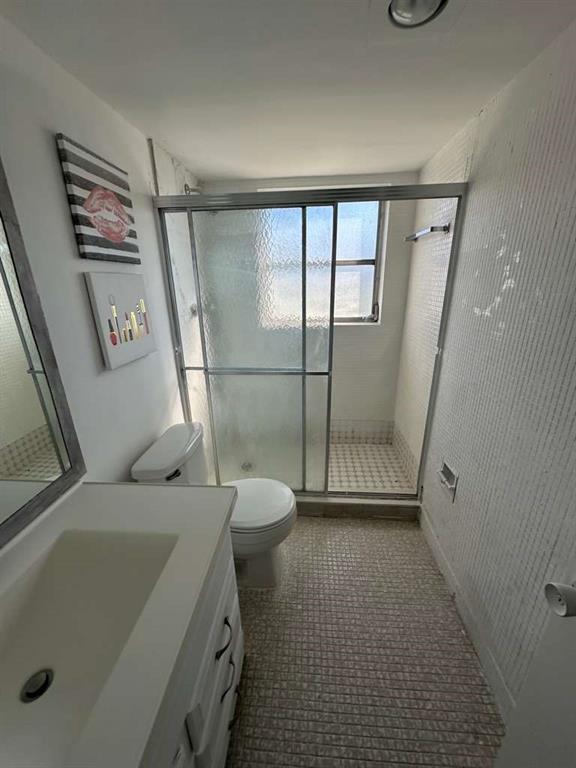 2681 South Course Drive, Unit 612 Pompano Beach, FL 33069 - Photo 23 of 27 a bathroom with a sink a toilet and a shower