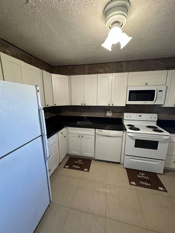 2681 South Course Drive, Unit 612 Pompano Beach, FL 33069 - Photo 4 of 27 a kitchen with a refrigerator and a stove top oven