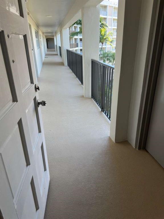 2681 South Course Drive, Unit 612 Pompano Beach, FL 33069 - Photo 7 of 27 a view of a hallway with furniture and stairs