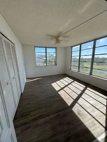 a view of wooden floor and windows in a room