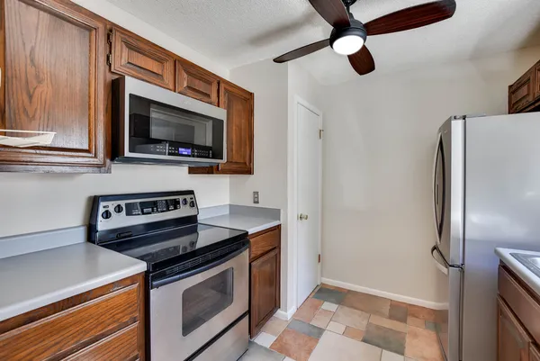 a kitchen with stainless steel appliances granite countertop a sink and a refrigerator