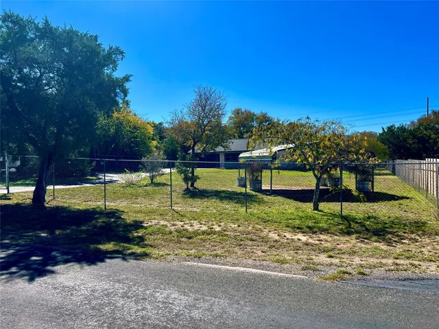 a view of a garden with a bench in a garden