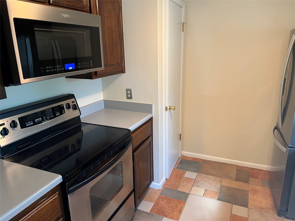 16001 Awalt Drive Austin, TX 78734 - Photo 8 of 22 a kitchen with a stove and a microwave