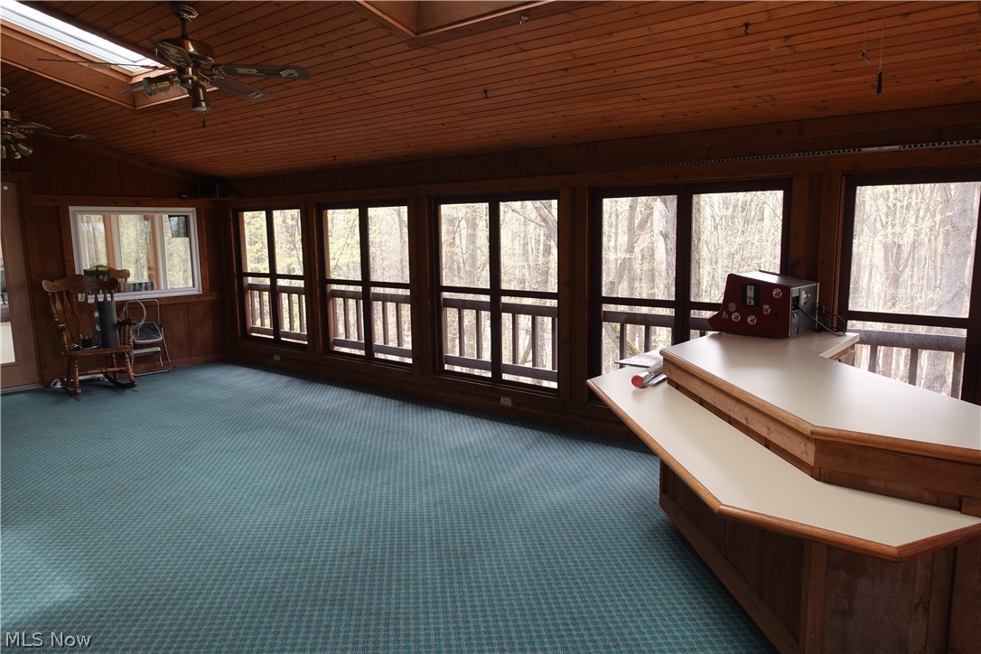 15488 Hatfield Road Rittman, OH 44270 - Photo 20 of 36 Unfurnished sunroom with wood ceiling, ceiling fan, and vaulted ceiling with skylight