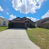 a front view of a house with a garden and yard
