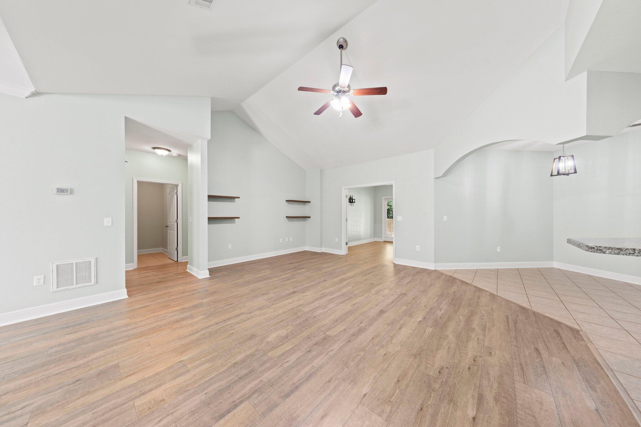 208 Foxchase Way Crestview, FL 32536 - Photo 13 of 51 a view of empty room with wooden floor