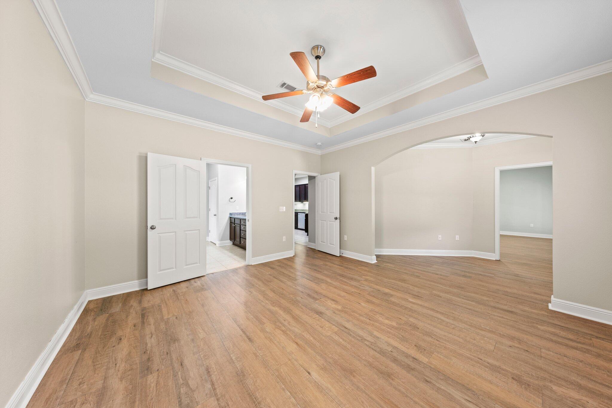 208 Foxchase Way Crestview, FL 32536 - Photo 23 of 51 a view of empty room with wooden floor and ceiling fan