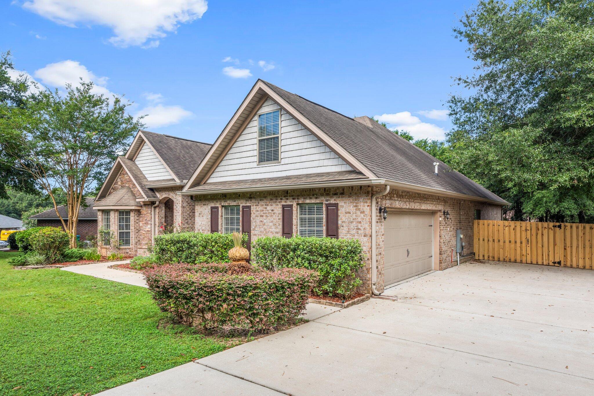 208 Foxchase Way Crestview, FL 32536 - Photo 3 of 51 a front view of a house with a garden
