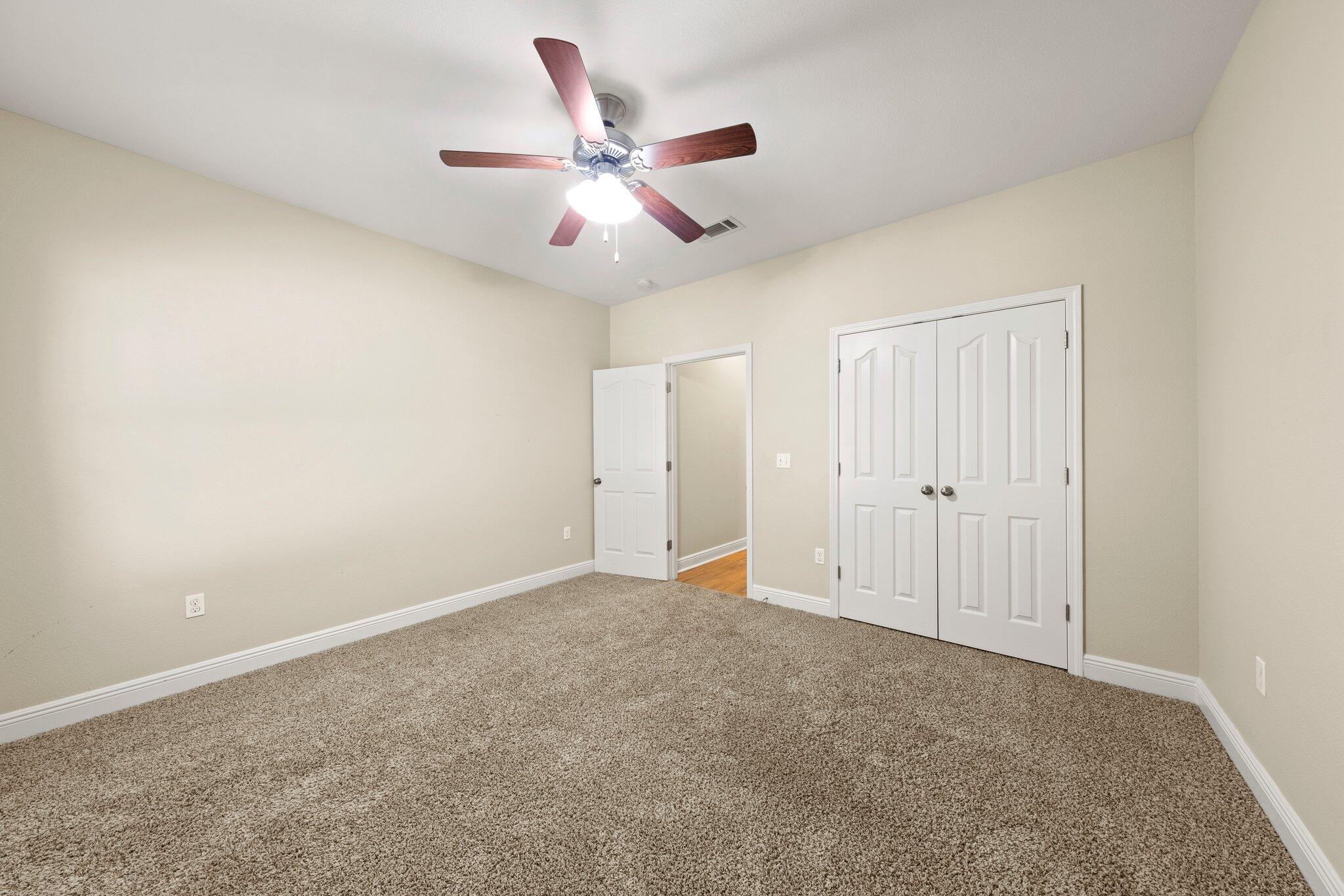 208 Foxchase Way Crestview, FL 32536 - Photo 35 of 51 an empty room with closet and a chandelier fan