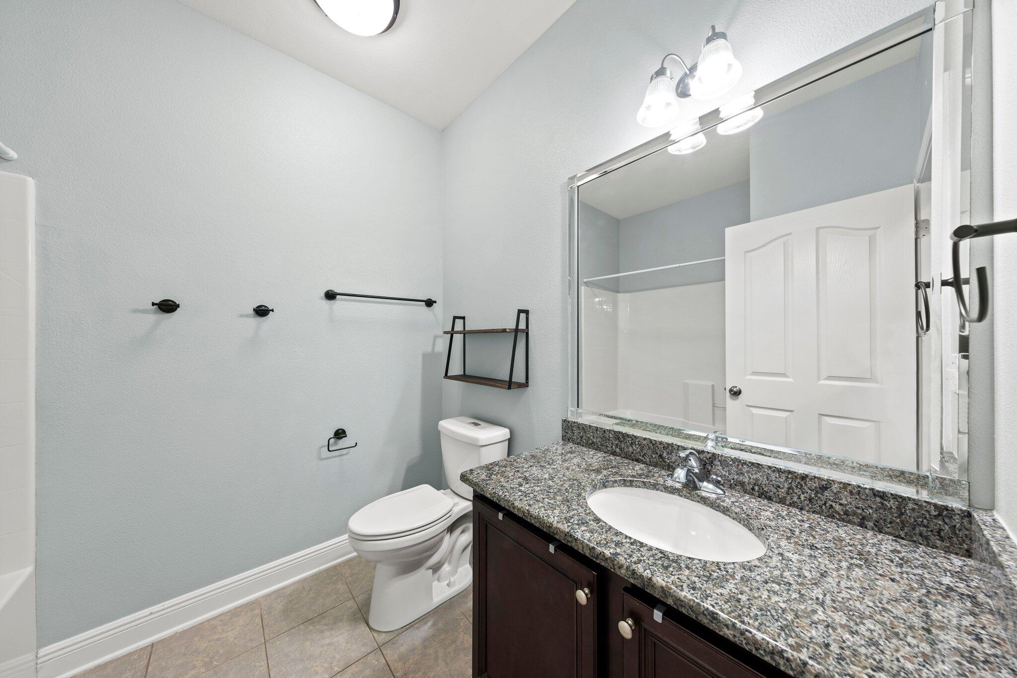 208 Foxchase Way Crestview, FL 32536 - Photo 36 of 51 a bathroom with a granite countertop sink a toilet and a mirror
