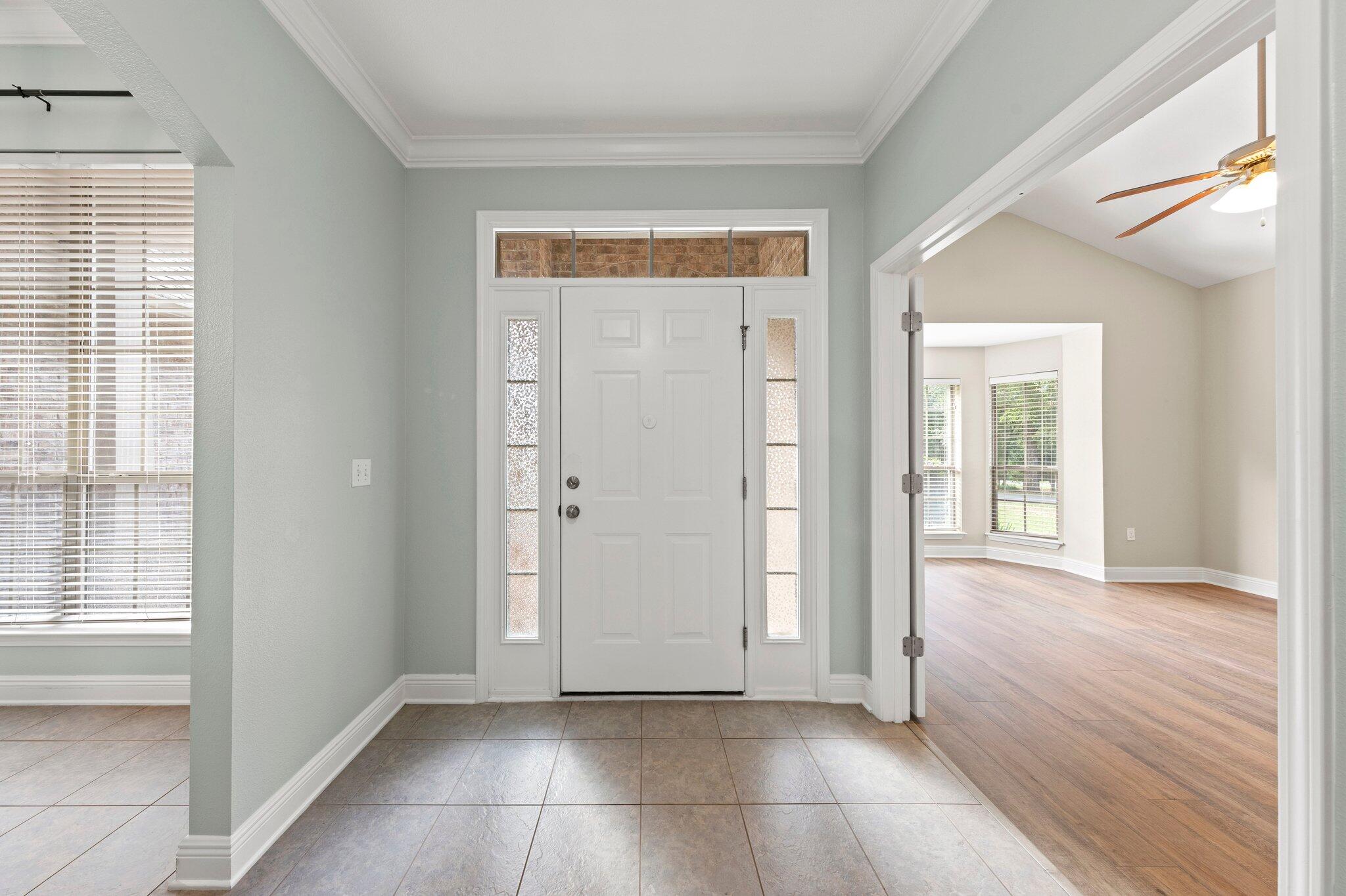 208 Foxchase Way Crestview, FL 32536 - Photo 6 of 51 a view of an empty room with wooden floor and a window