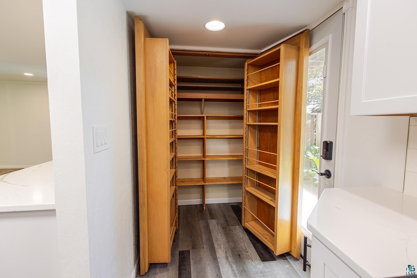 29 Ridge Road Esko, MN 55733 - Photo 13 of 41 Custom pantry storage with wood-finish shelving and pull-out spice racks