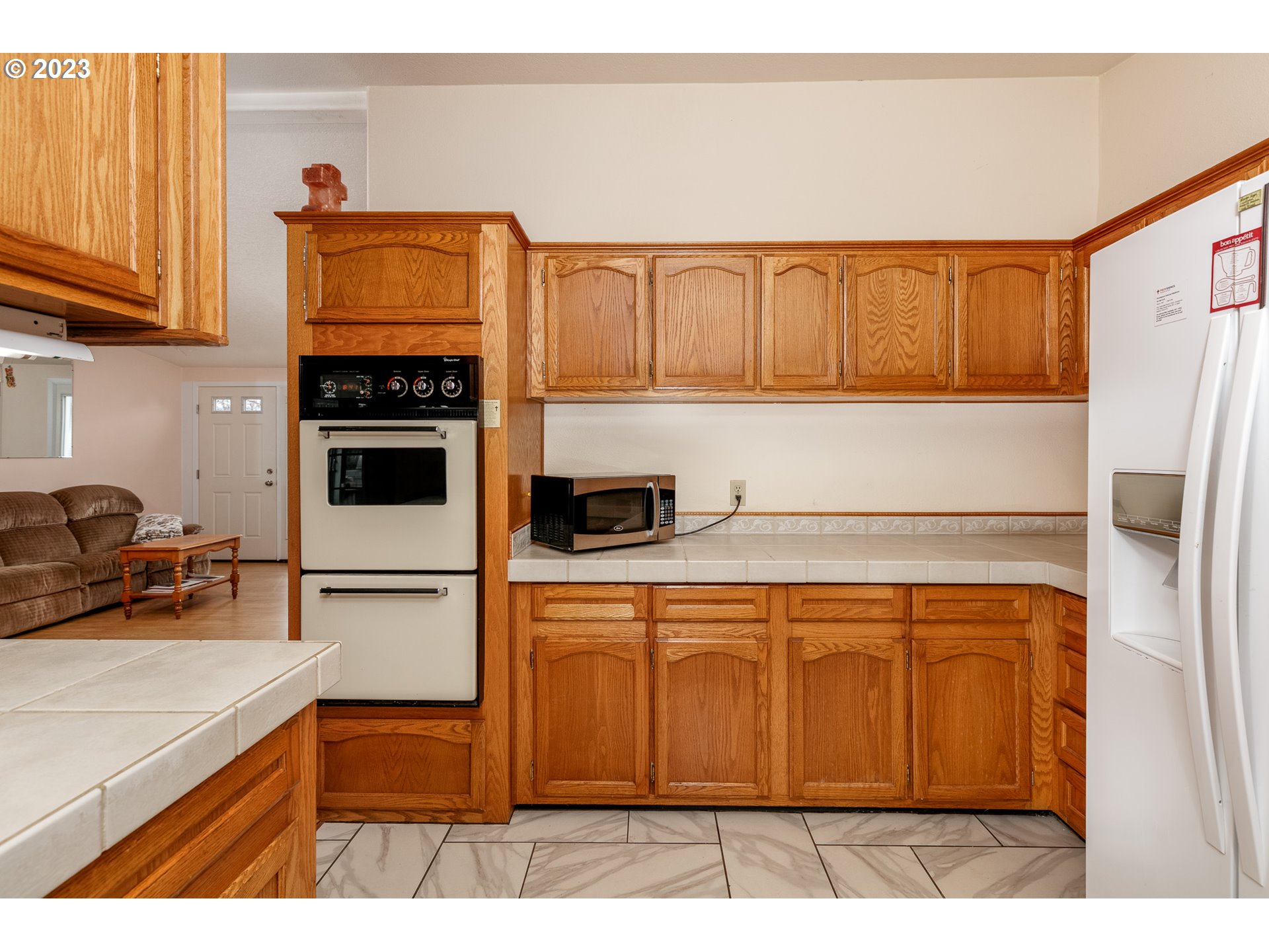 1404 Dillon Road Hood River, OR 97031 - Photo 6 of 30 a kitchen with a refrigerator and a stove top oven