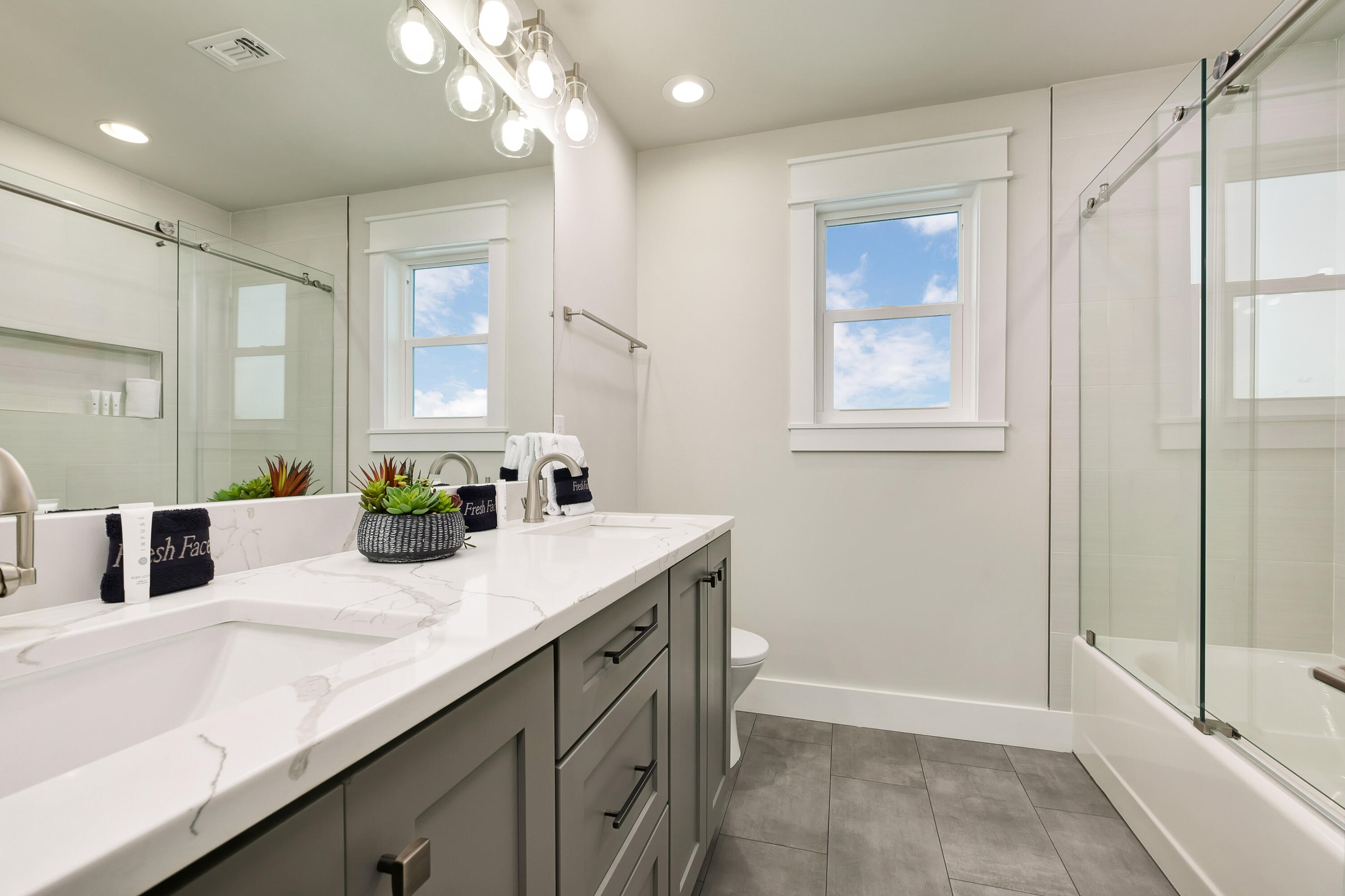 76 Hotz Avenue Santa Rosa Beach, FL 32459 - Photo 39 of 71 a bathroom with a granite countertop sink a toilet and mirror