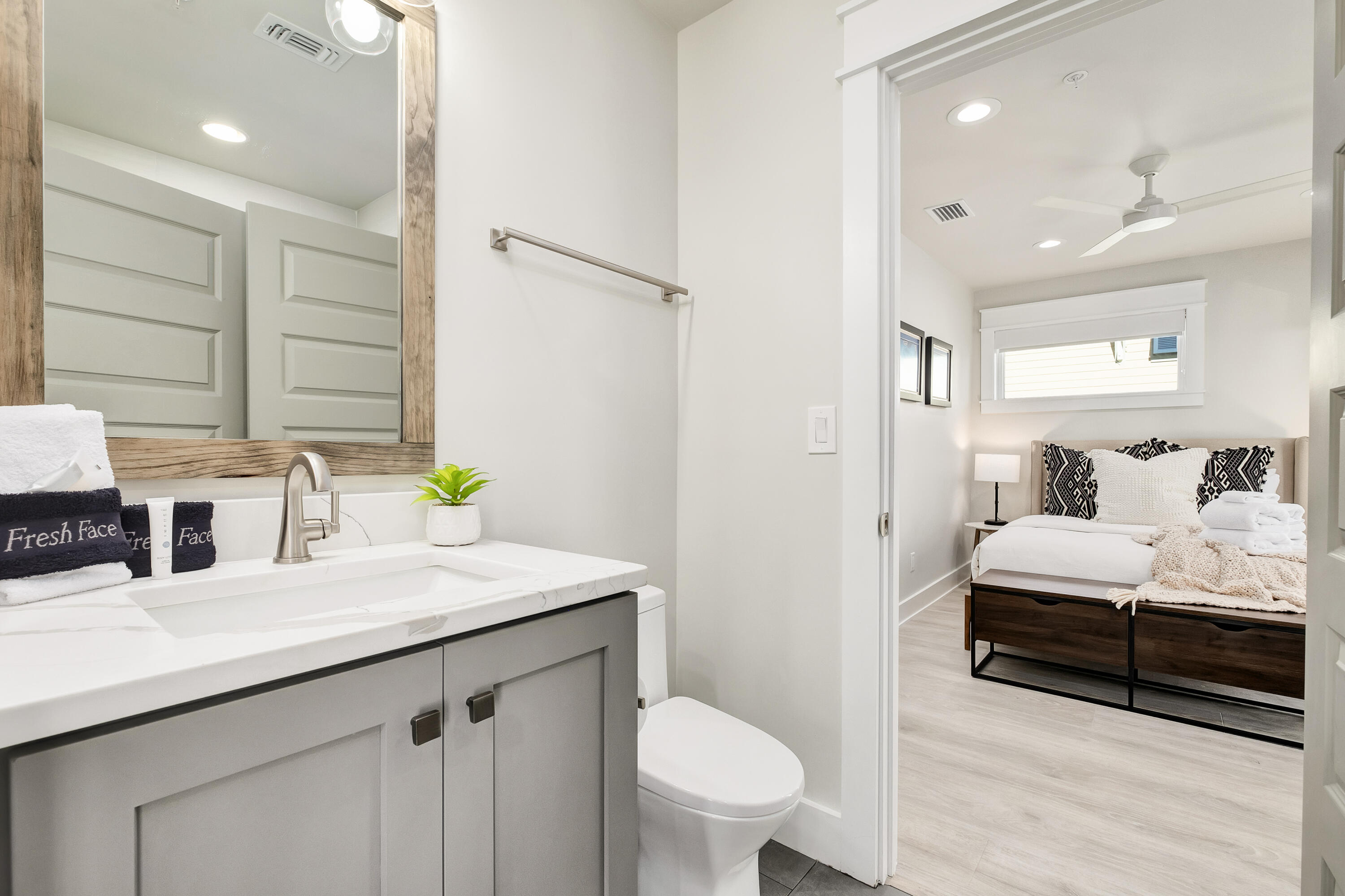 76 Hotz Avenue Santa Rosa Beach, FL 32459 - Photo 41 of 71 a en suite bathroom with a double vanity sink a toilet and a mirror