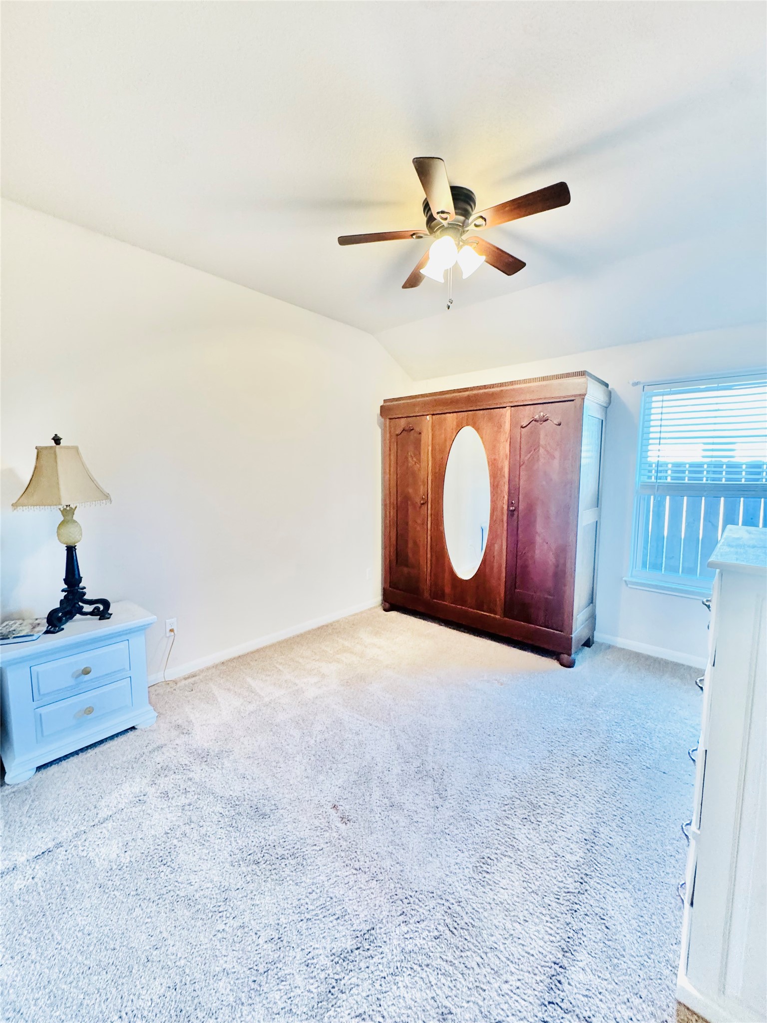 413 Gettysburg Loop Elgin, TX 78621 - Photo 20 of 32 Unfurnished bedroom featuring a ceiling fan, vaulted ceiling, and light colored carpet