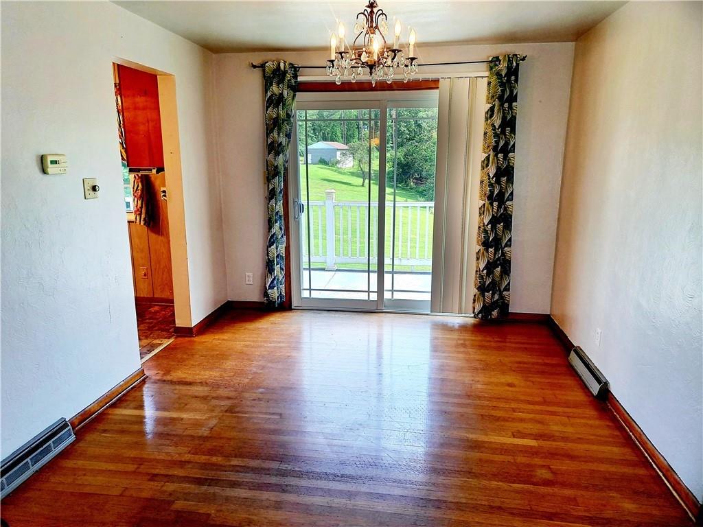 530 Scott Hollow Road Burgettstown, PA 15021 - Photo 6 of 21 a view of an empty room with wooden floor and a window