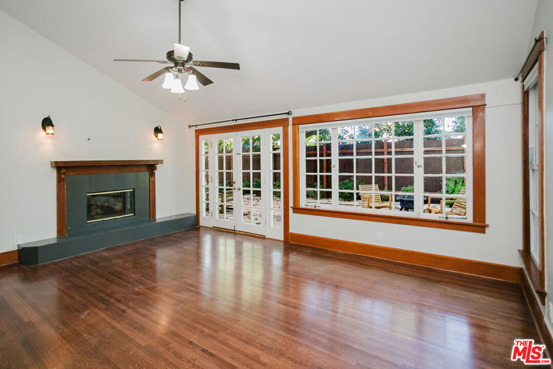 13239 Addison Street Sherman Oaks, CA 91423 - Photo 15 of 29 a view of an empty room with wooden floor fireplace and a window