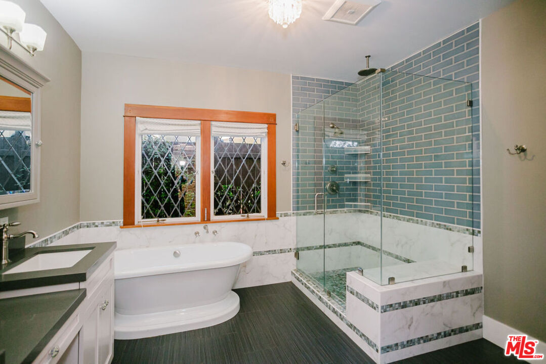 13239 Addison Street Sherman Oaks, CA 91423 - Photo 17 of 29 a bathroom with a tub sink and mirror