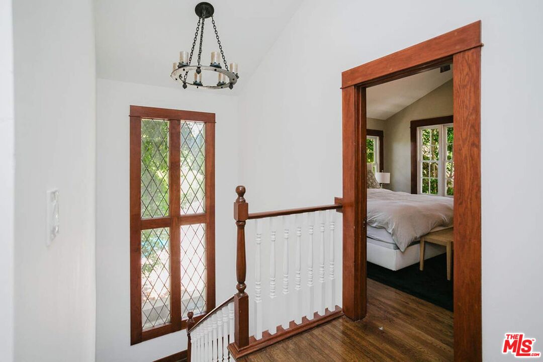 13239 Addison Street Sherman Oaks, CA 91423 - Photo 19 of 29 a view of a hallway with wooden floor and stairs