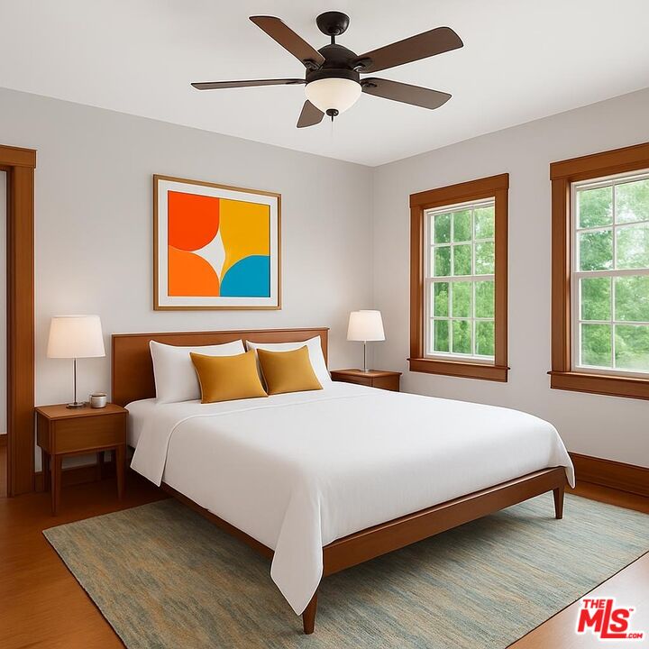 13239 Addison Street Sherman Oaks, CA 91423 - Photo 20 of 29 a bedroom with a bed and painting on the wall