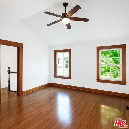 a spacious bedroom with a bed and a window