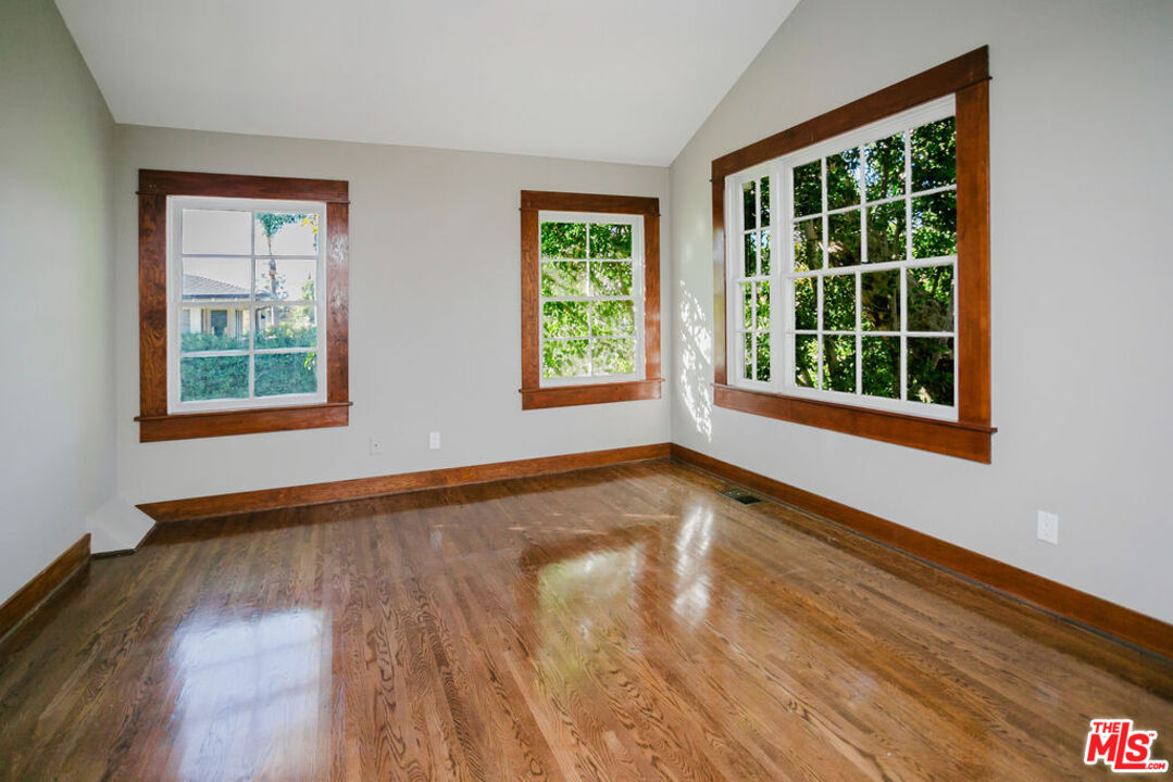 13239 Addison Street Sherman Oaks, CA 91423 - Photo 23 of 29 a view of an empty room with wooden floor and a window