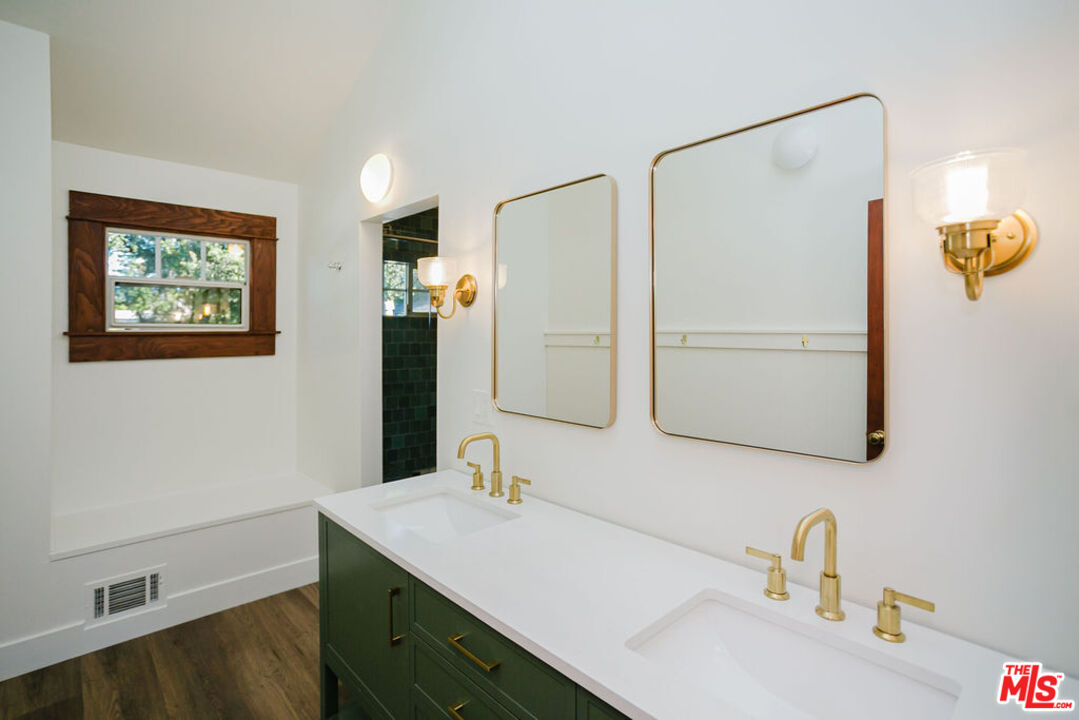 13239 Addison Street Sherman Oaks, CA 91423 - Photo 24 of 29 a bathroom with a sink and a mirror