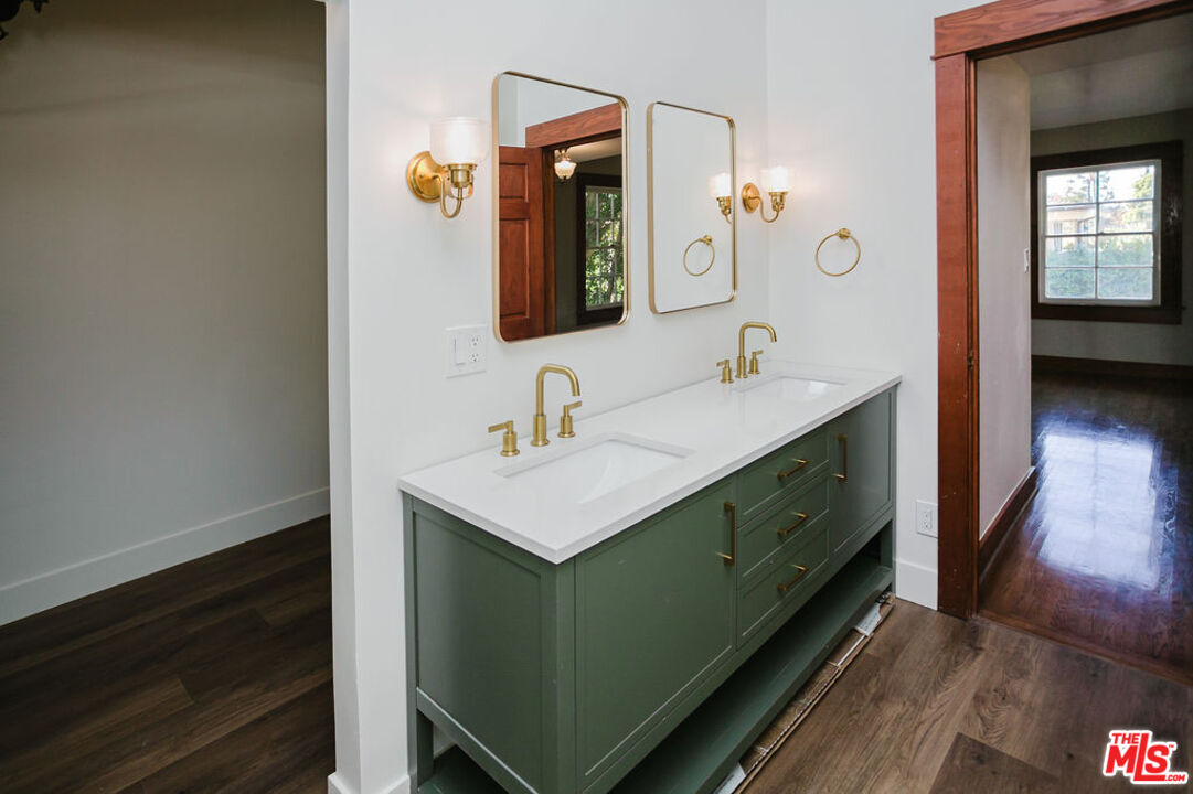 13239 Addison Street Sherman Oaks, CA 91423 - Photo 25 of 29 a bathroom with a sink and a mirror